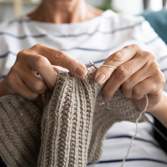 73_9282_09Jan2025101056_Close up view hands holding needles and knitting 540px.jpg